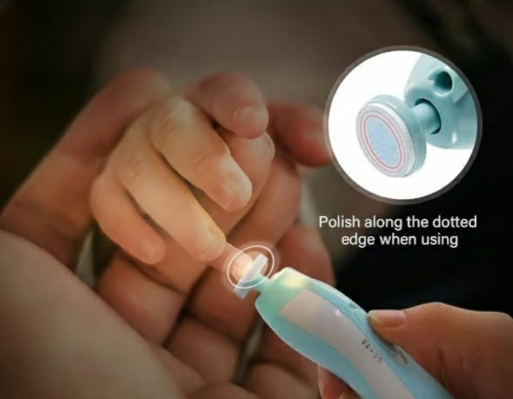 Close-up photo of an adult's hand gently using the electric baby nail trimmer on an infant's tiny finger, highlighting the soft filing head and safety.